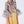 Load image into Gallery viewer, bold floral blouse with bell sleeves, styled with a minimal yellow skirt