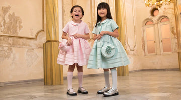 Girls wearing pastel pink and mint occasion dresses
