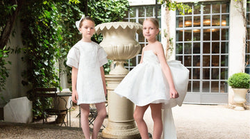 Luxury white flower girl dresses in elegant garden setting