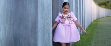 Girl wearing a pink ruffle bow special occasion dress