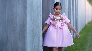 Girl wearing a pink ruffle bow special occasion dress