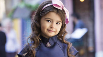 chic navy blouse with sparkling brooch