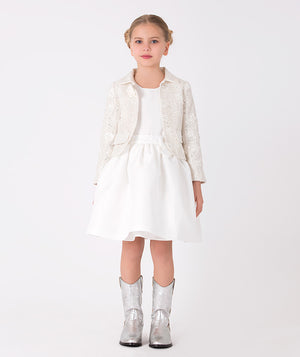 an ivory sequin jacket and white skirt