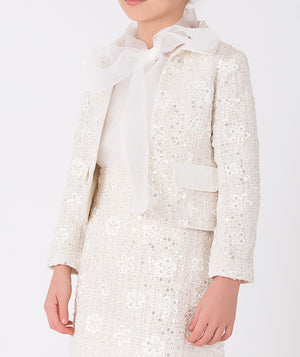 Elegant ivory sequin jacket with delicate floral detailing and satin bow closure