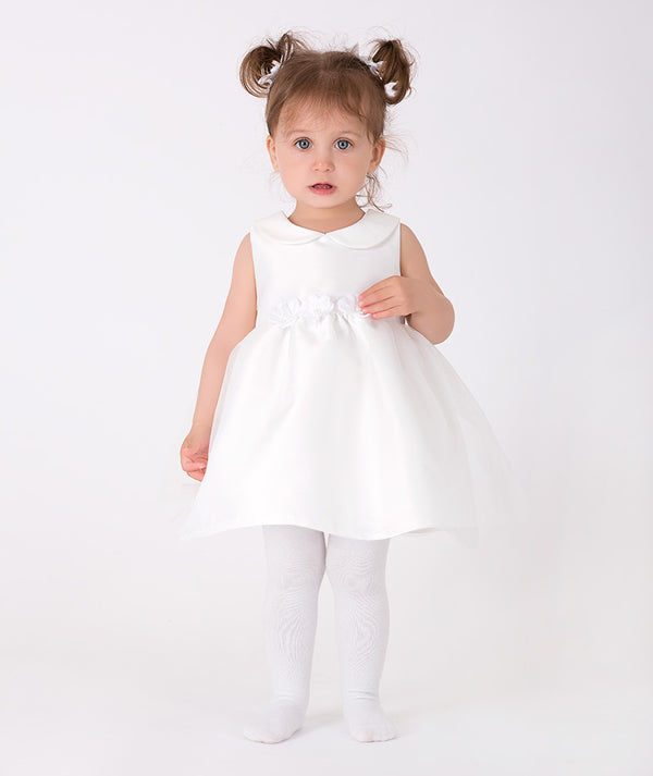 a sleeveless white dress with a Peter Pan collar and floral waist detailing