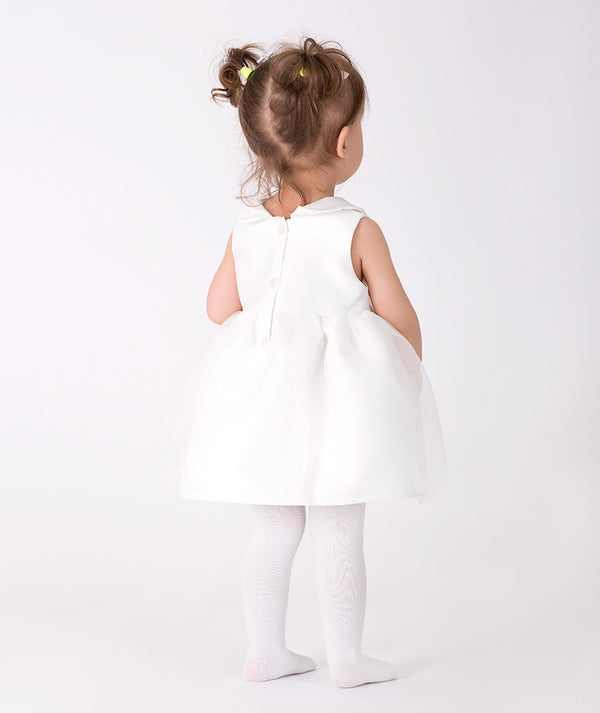 Charming white baby dress with a flared silhouette, Peter Pan collar, and delicate floral accents at the waist