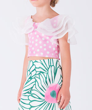 pink polka dotted blouse with green floral skirt