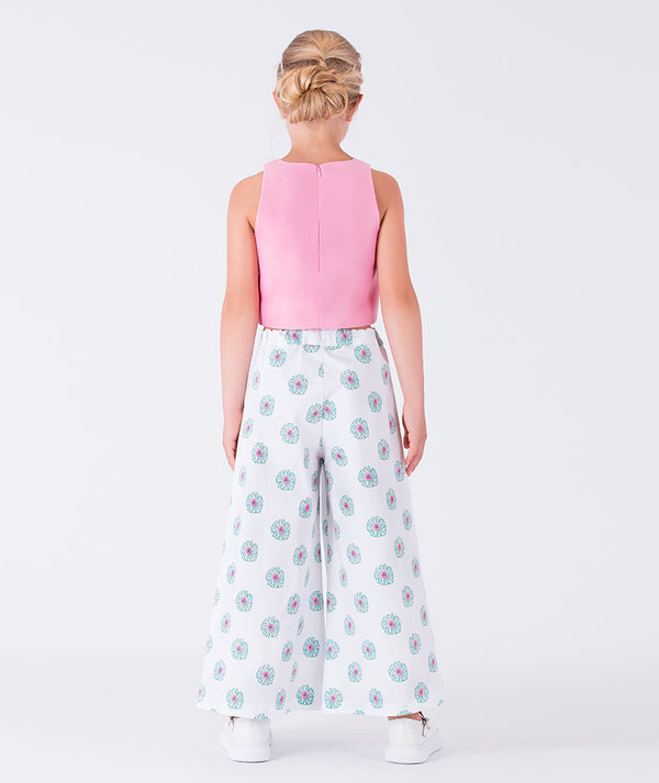 sleeveless pink top and flowing white floral pants 