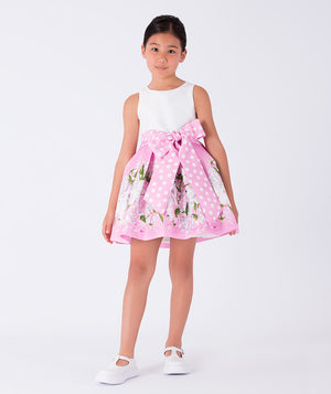 white and pink dress with floral prints and a big polka dotted bow on the waist