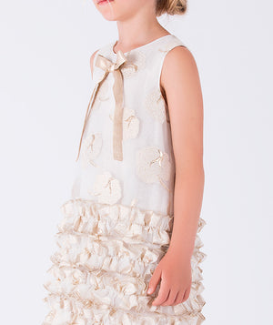 Cream sequin dress with layered gold ruffle detailing and a bow