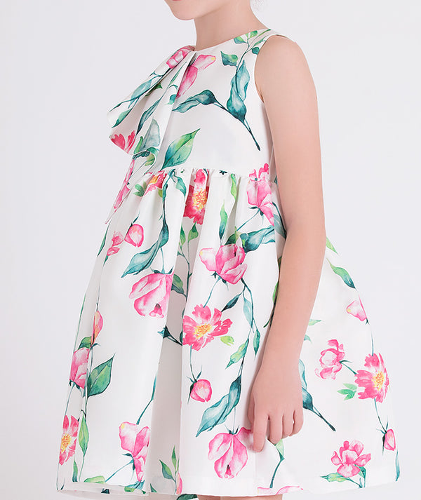 a sleeveless floral A-line dress with a large ruffle detail on the shoulder