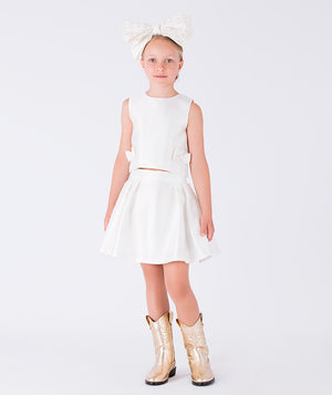 A structured white top with bow details and skirt duo