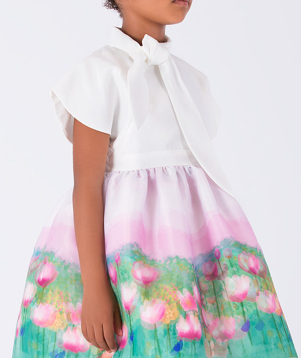 chic dress with floral skirt and a bow around the neck