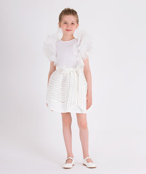 white blouse with ruffled sleeves and striped skirt with a bow on the waist