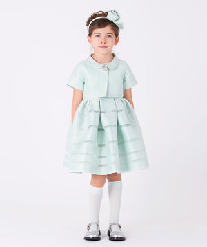 Classic short-sleeve dress in soft mint satin with pleated skirt, pearl button detail, and matching flower headband—perfect for elegant celebrations.