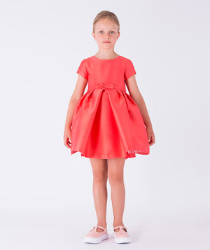 A structured coral dress featuring a little bow on the waist