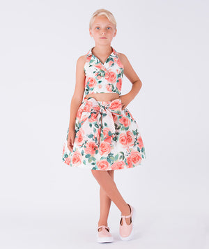 A halter-neck floral blouse and matching skirt with a big bow on the waist