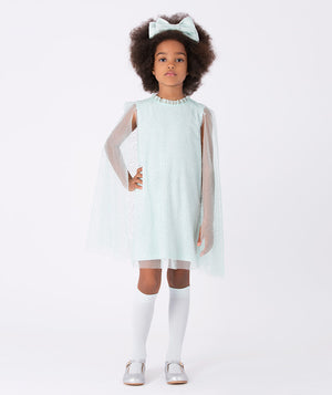 A magical mint green dress with glittery mesh cape sleeves, ruffled neckline, and matching oversized bow—perfect for twirling at parties and standout moments.