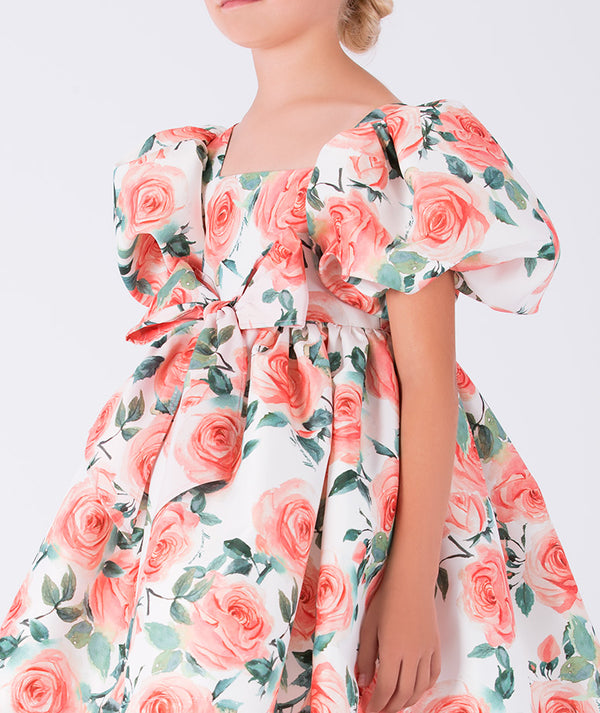 delightful puff-sleeve dress with a vibrant rose print and bow-tied waist