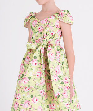 green floral dress with a bow on the waist