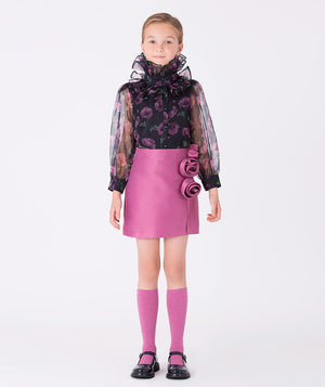Navy organza blouse with sheer sleeves and ruffled collar, blooming with purple orchids, paired with a mulberry skirt adorned with delicate 3D roses.