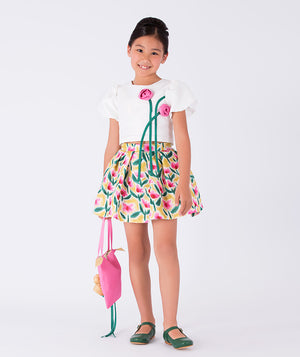 a floral print skirt paired with a white top