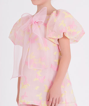 pink floral dress with balloon sleeves and a big bow on the front