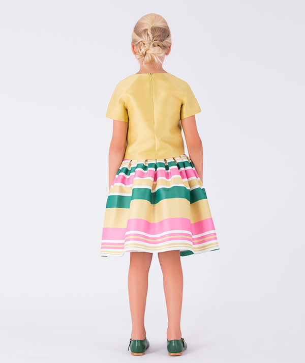 yellow top paired with a striped skirt