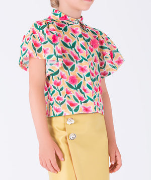  floral shirt paired with a sleek yellow skirt