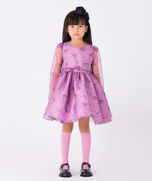 Floral-print dress with sheer organza sleeves, a layered skirt, and delicate ruffles. A magical dress designed to inspire twirls and spark imagination.