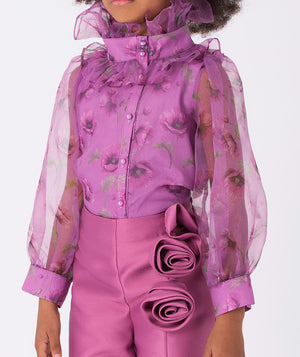 Lilac blouse with sheer sleeves and a high ruffled collar, paired with mulberry pants adorned with delicate 3D roses on the front