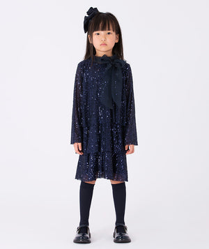 A navy glitter dress with long sleeves and a soft, sheer bow—a playful mix of sparkle and charm.