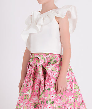 white one shoulder ruffled blouse and pink floral skirt