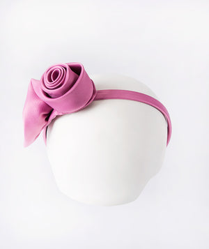 Mulberry headband accented with a delicate 3D rose for a touch of sweet elegance.