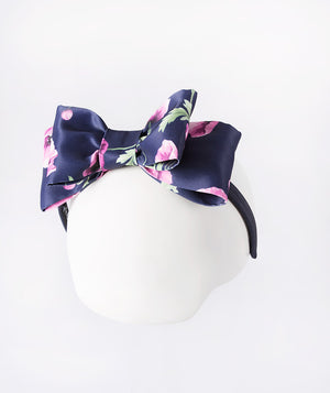 Navy headband sprinkled with delicate purple orchids—a subtle pop of floral charm.