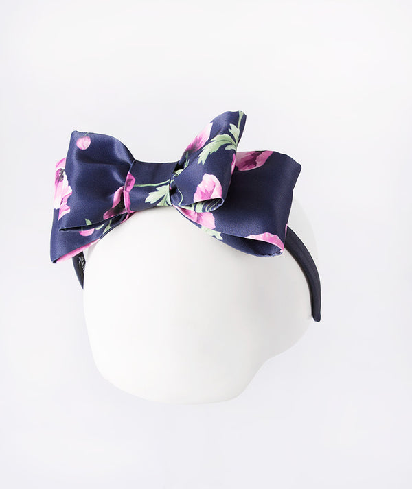 Navy headband sprinkled with delicate purple orchids—a subtle pop of floral charm.