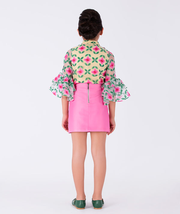 vibrant floral blouse paired with a pink ruffled skirt