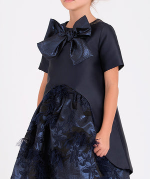 Stylish navy blue formal blouse for girls featuring a statement bow and feathered floral skirt details