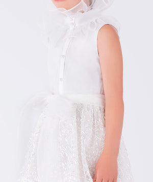 chic white blouse with ruffled neckline and shimmering skirt with a bow
