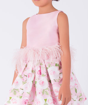 pink blouse with feathers on the waist and floral skirt
