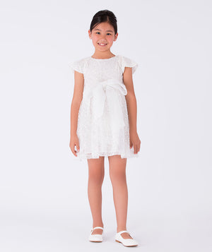 white sequined dress with a bow on the waist