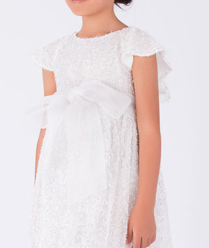 shimmering white dress with an organza bow on the waist