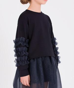 a stylish navy tulle skirt and ruffled sleeve top