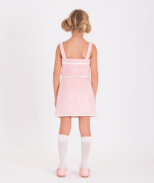 a modern pink crop top and skirt set, complete with stylish white trim and functional pocket accents