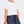 Load image into Gallery viewer, Elegant outfit featuring a short-sleeve white blouse and textured navy skirt
