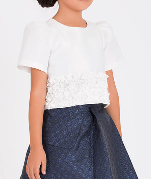 Elegant outfit featuring a short-sleeve white blouse and textured navy skirt