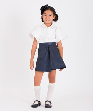 White short-sleeved blouse paired with a navy pleated skirt