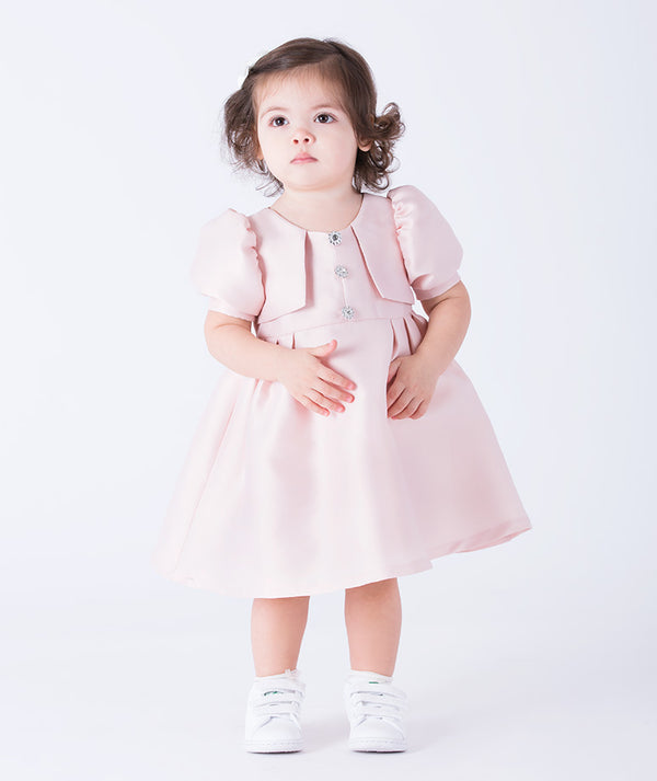 Adorable puff-sleeve baby dress crafted from soft satin with jeweled buttons and pleated detailing. Available in pastel mint and blush pink—perfect for birthdays, holidays, and special family moments. Comfortable, elegant, and picture-ready!
