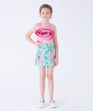 striking pink rosette top paired with a whimsical floral skirt