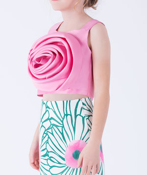 pink rosette top paired with a whimsical floral skirt